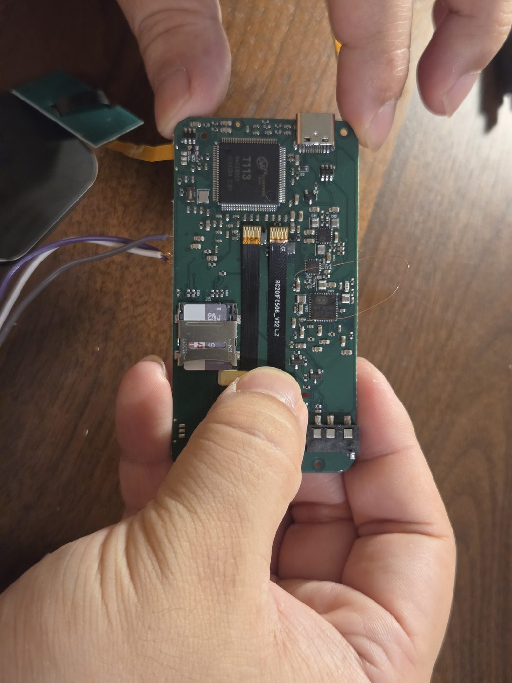 The main board held between two fingers